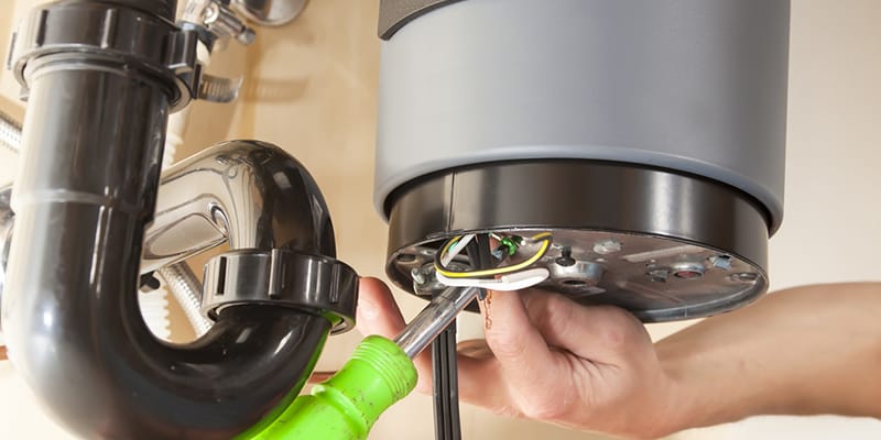 Technician repairing the heating element of a water heater in San Bernardino