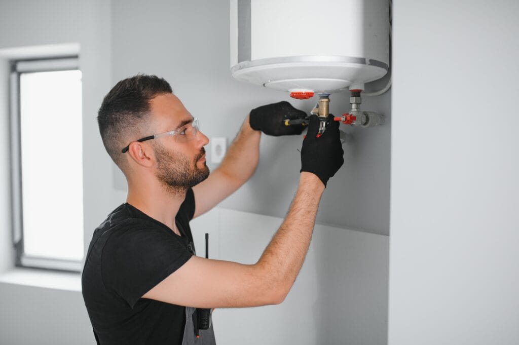 Technician performing water heater maintenance in San Bernardino