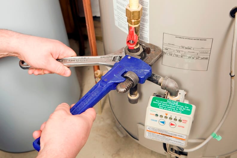 Plumber repairing a water heater valve in San Bernardino